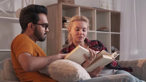 Couple Relaxing at Home Reading a Book