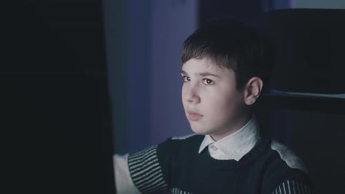 Year Old Boy Uses Computer at Night Home