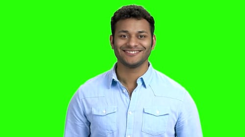 Smiling Young Adult Against Green Background