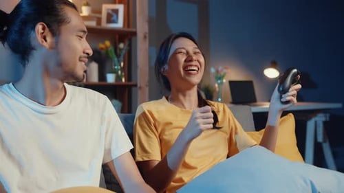 Happy Couple Plays Video Games Together at Home