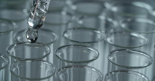 Pipette Dripping Clear Liquid into Test Tubes