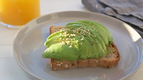 Preparing Delicious Avocado Toast with Seeds and Juice