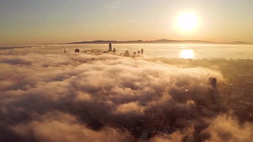 City Rises Above Clouds at Sunrise Aerial