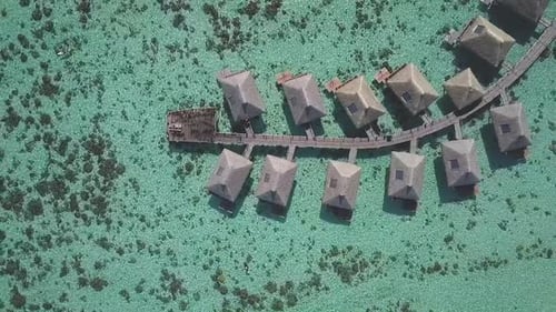Drone overwater bungalows tropical ocean coral reefs luxury resort