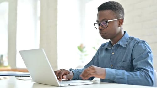 Young African Man Standing and Going Away in Office