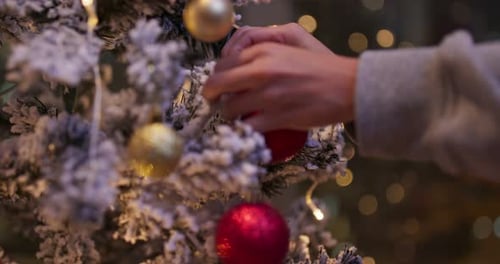 Decorating Christmas Tree With Baubles and Ribbons