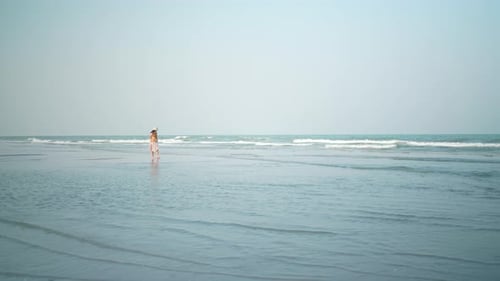 Asian woman walking slow-motion on the beach, summer vacation on the tropical sea beach