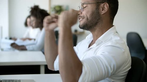 Side View of Tired Young Man Finishing Work