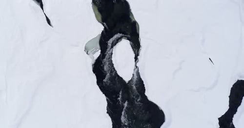 Stream flowing on snowy area during winter 4k