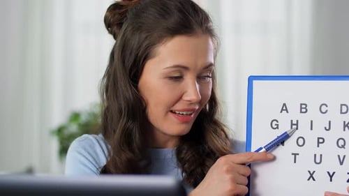 Woman Teaches Alphabet Online From Home Close Up