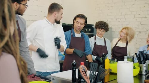 Chef Demonstrating Knife Skills to Cooking Class