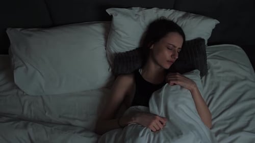 Top View of Woman Trouble Sleeping in Loft Bedroom. Beautiful Young Woman Having Bad Dream. Woman