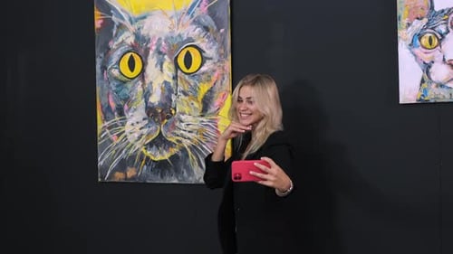 Young Woman is Taking Funny Photo By Mobile Phone in Modern Art Gallery