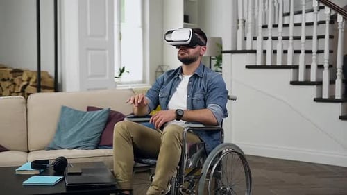Man in Wheelchair Using VR Headset at Home