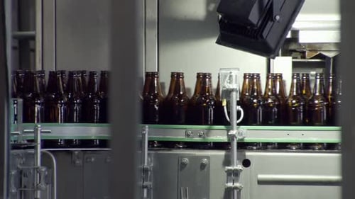 Bottles Moving on Conveyor Belt in Factory