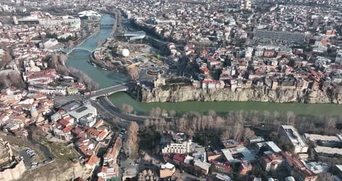 Aerial view of Metekhi church in old Tbilisi located on cliff near river Kura. Georgia 2022 winter