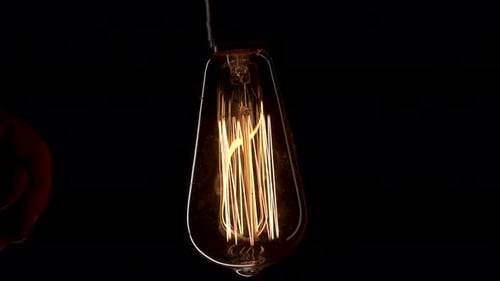 Close Up Turn on and Off Retro Old Vintage Tungsten Lamp with Dust Inside Glass. Scary Dark Footage