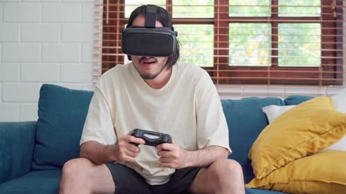 Man Playing VR Game on Couch at Home