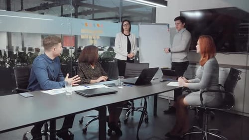 Professionals Collaborate During an Office Presentation