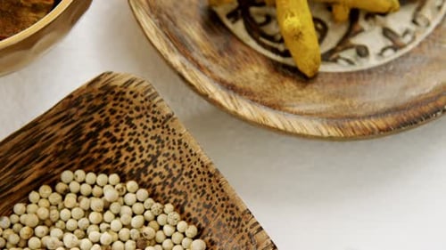 Turmeric raw seed, bay leaf and seed in bowl 4k