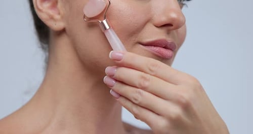 Close Up Portrait Female Using Natural Massager Tool for Skin Care and Spa Beauty Treatment