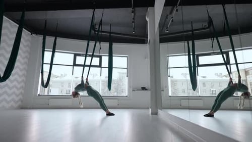 Young Beautiful Woman Practice in Aero Stretching Swing