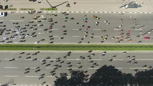 aerial top view of cyclists at professional bike road race on city streets