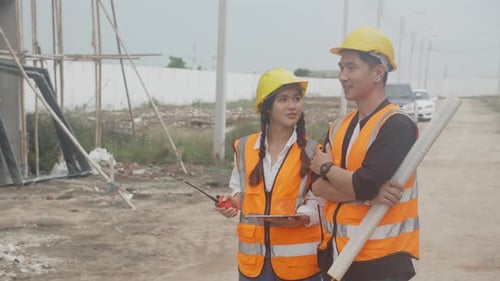 Group team of engineer and architect holding blueprint and explaining using radio communication.
