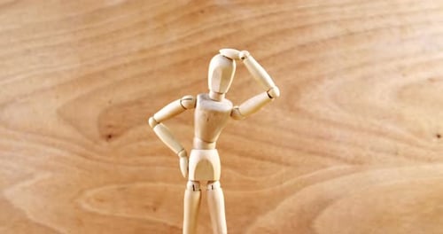 Wooden Mannequin Standing Against Wooden Panel