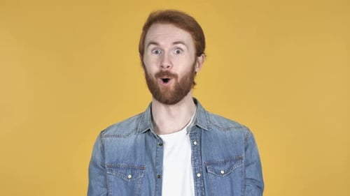 Man Expressing Surprise on Yellow Background