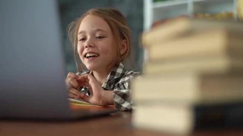 Closeup of Smiling Primary Child School Girl Talking to Online Teacher While Studying Online on
