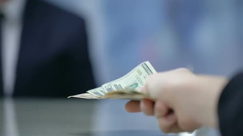 Client Paying Money to Hotel Administrator, Check-In at Reception, Closeup