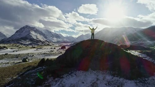 A Man Stands on Top of a Cliff and Enjoys a View Adventure and Travel Concept