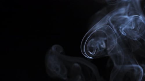 Wispy Blue Smoke Against a Black Background