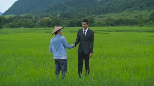Farmer And Businessman Shaking Hands