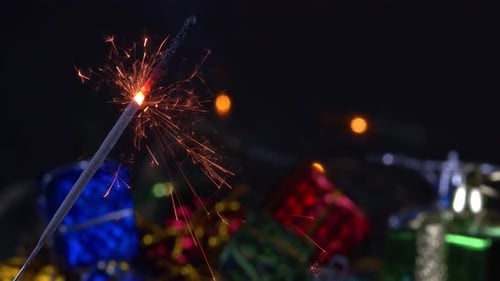 Christmas Sparkler Burning On Black And Light Background