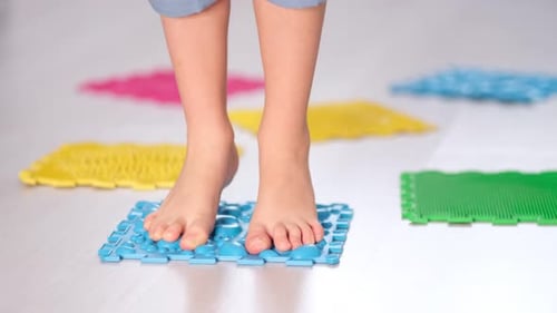 Child Treading on Textured Massage Mats for Foot Health
