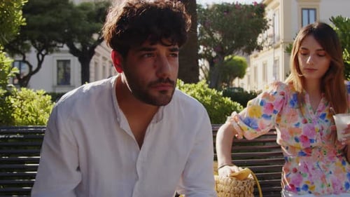 Young Couple Eats Ice Cream at the Park
