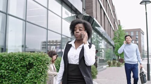 Woman Walking and Talking on Phone in City