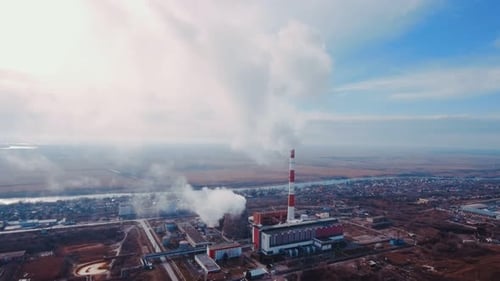 Aerial shot. Pipes with smoke: industrial production, plant, air pollution.
