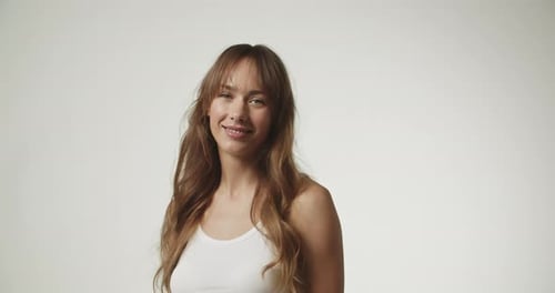 Smiling Woman With Long Brown Hair Posing