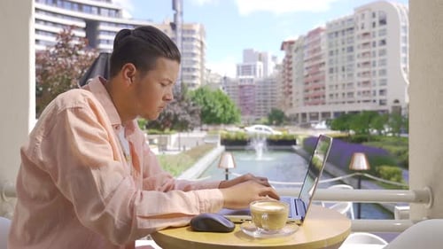 Young businessman working in cafe.