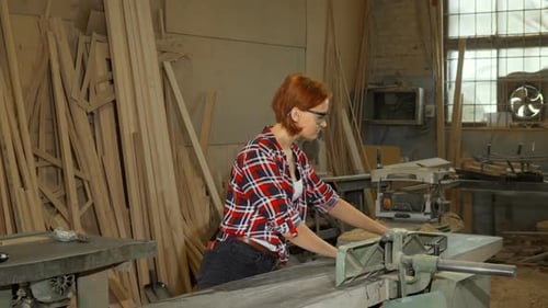 Female Carpenter Using Power Tools at Her Workshop