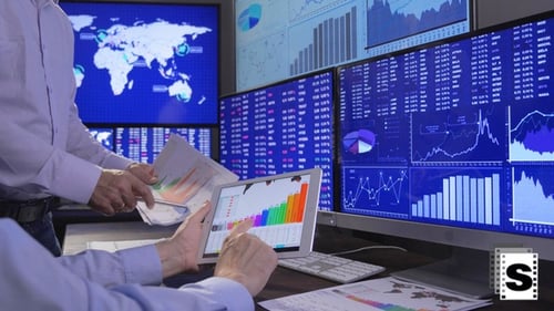 Financial Analysts Reviewing Charts in Modern Office