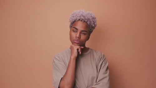 Thoughtful Young Adult with Stylish Purple Hair Ponders