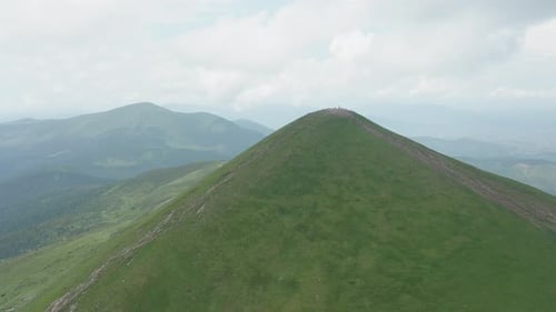 Aerial View of the Approaching Mountain Peak Against the Backdrop of a Beautiful Mountain Landscape