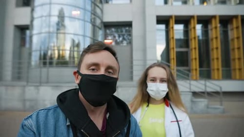 Healthcare Workers in Face Masks Outside Urban Building