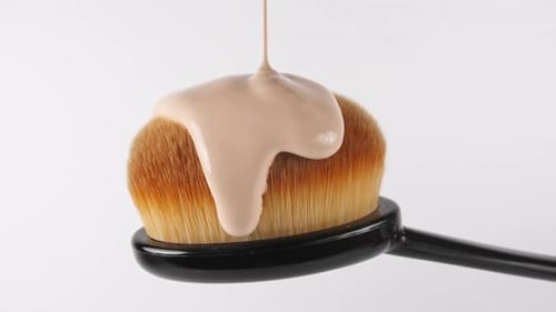 Liquid Foundation Face Makeup Pouring on Makeup Brush