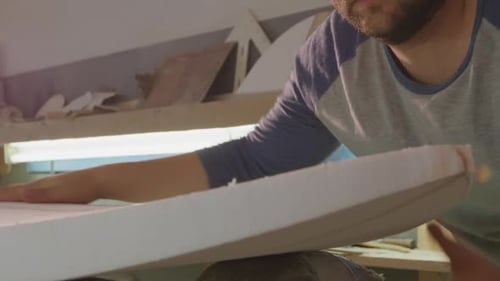 Male surfboard maker in his workshop