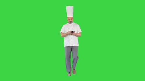 Head Cook Walking and Using Mobile Phone on a Green Screen Chroma Key